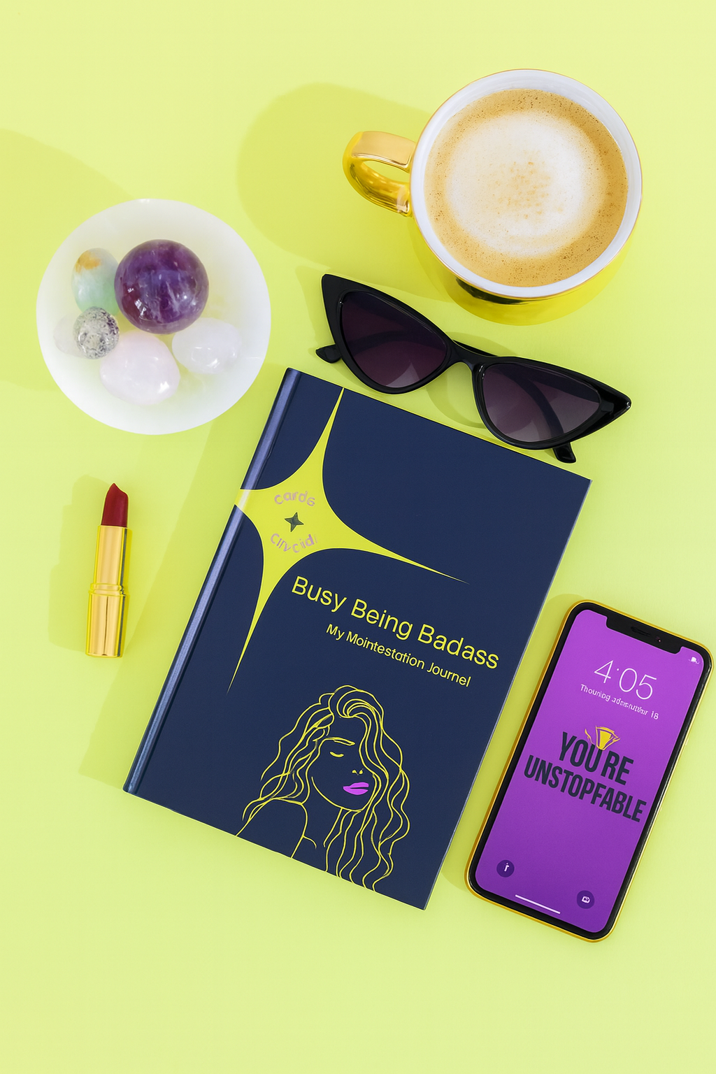 Book titled 'Busy Being Badass' with a phone, sunglasses, coffee, and other items on a yellow background