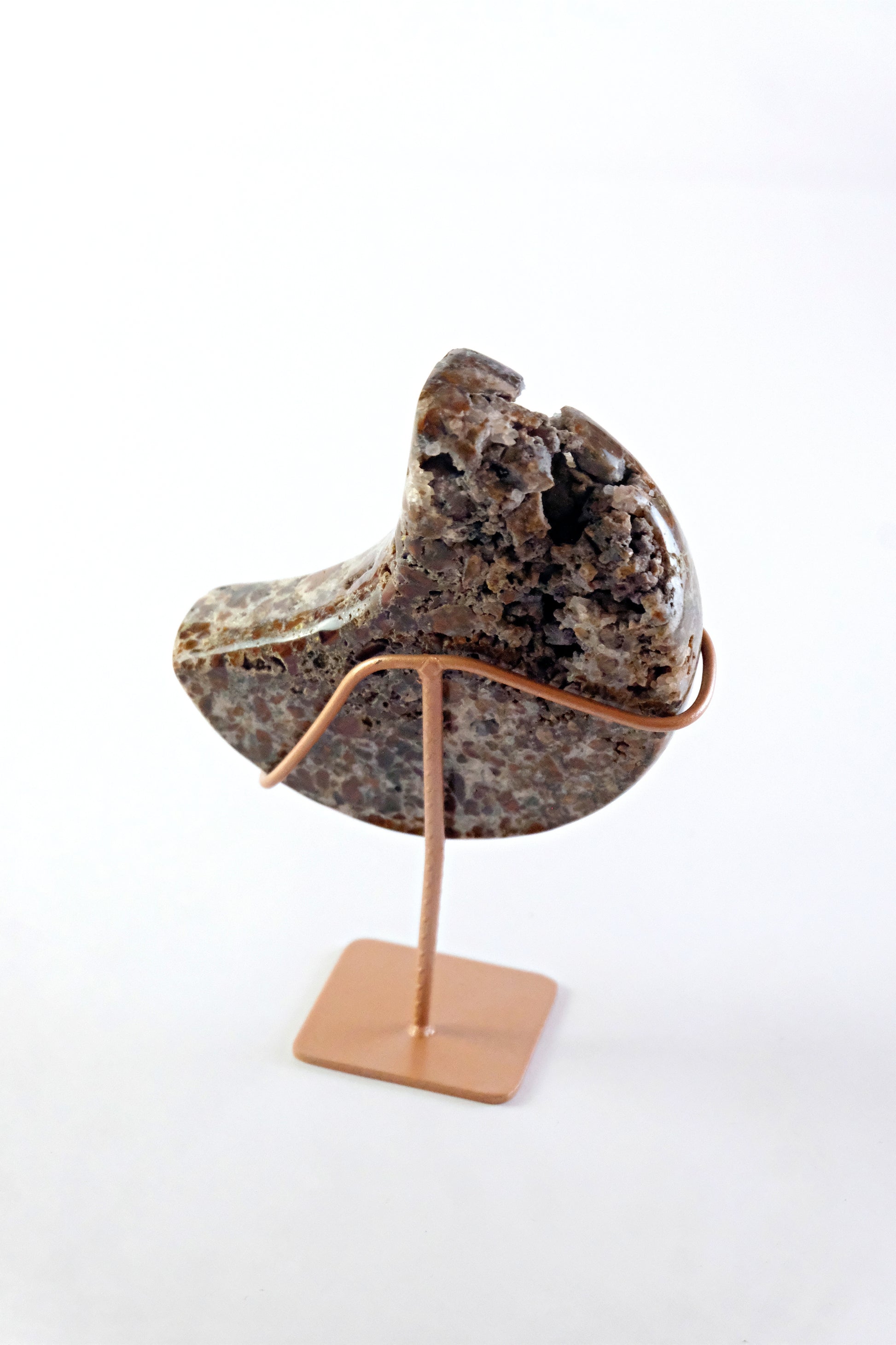 Decorative stone on a stand against a white background